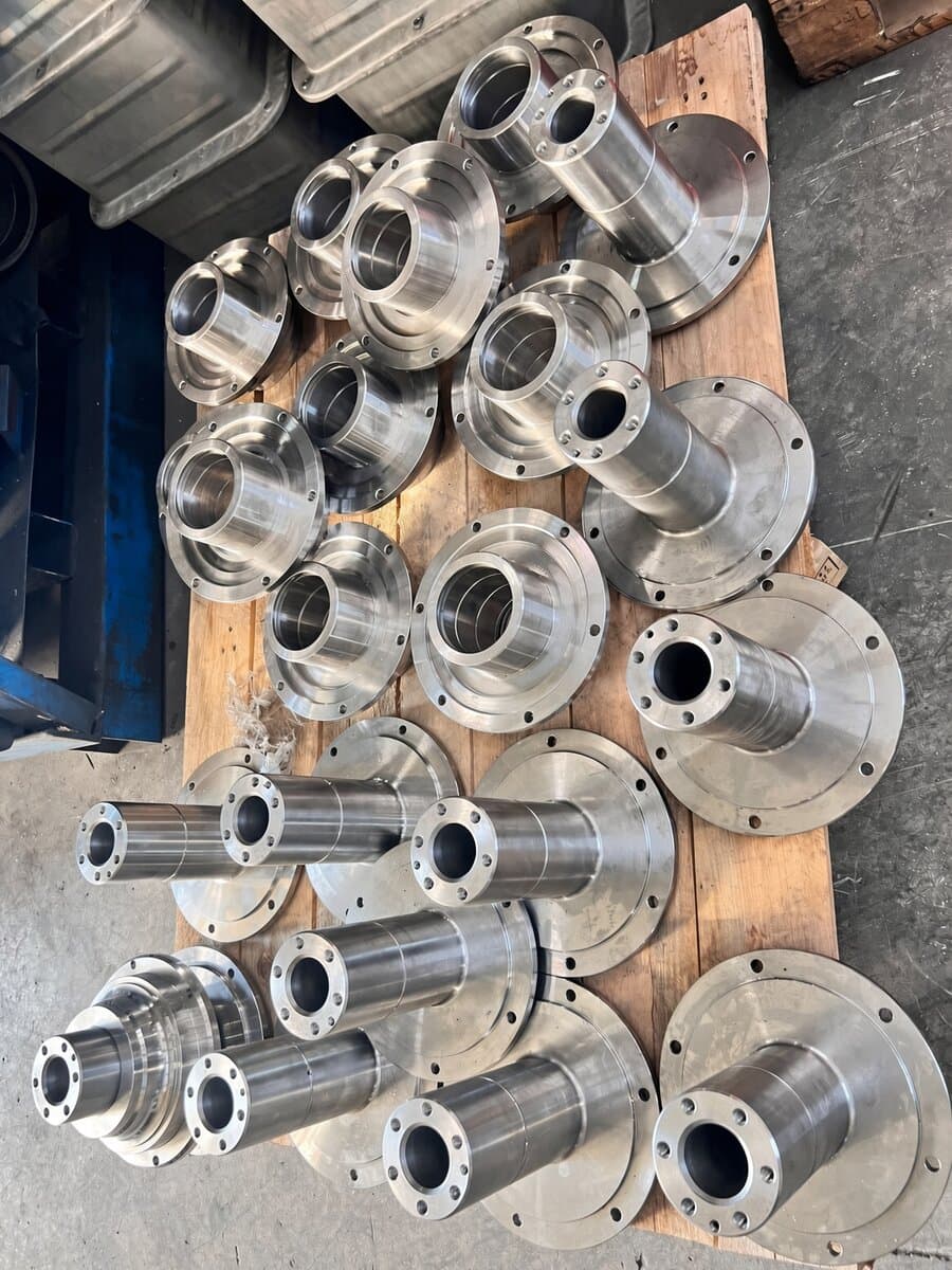 Machined hubs and flanges on a pallet at the M-Farm bench